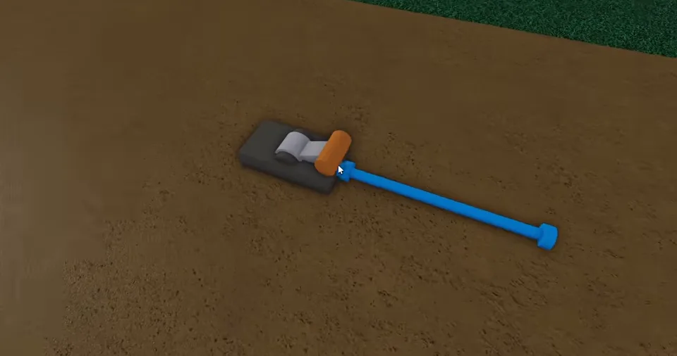 A grey lever with an orange handle connected to a bright blue wire on the ground